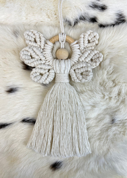 Macrame christmas ornament with tassel on a fur surface