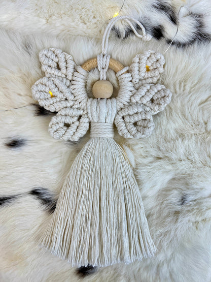 Macrame angel ornament with tassel on a fur surface