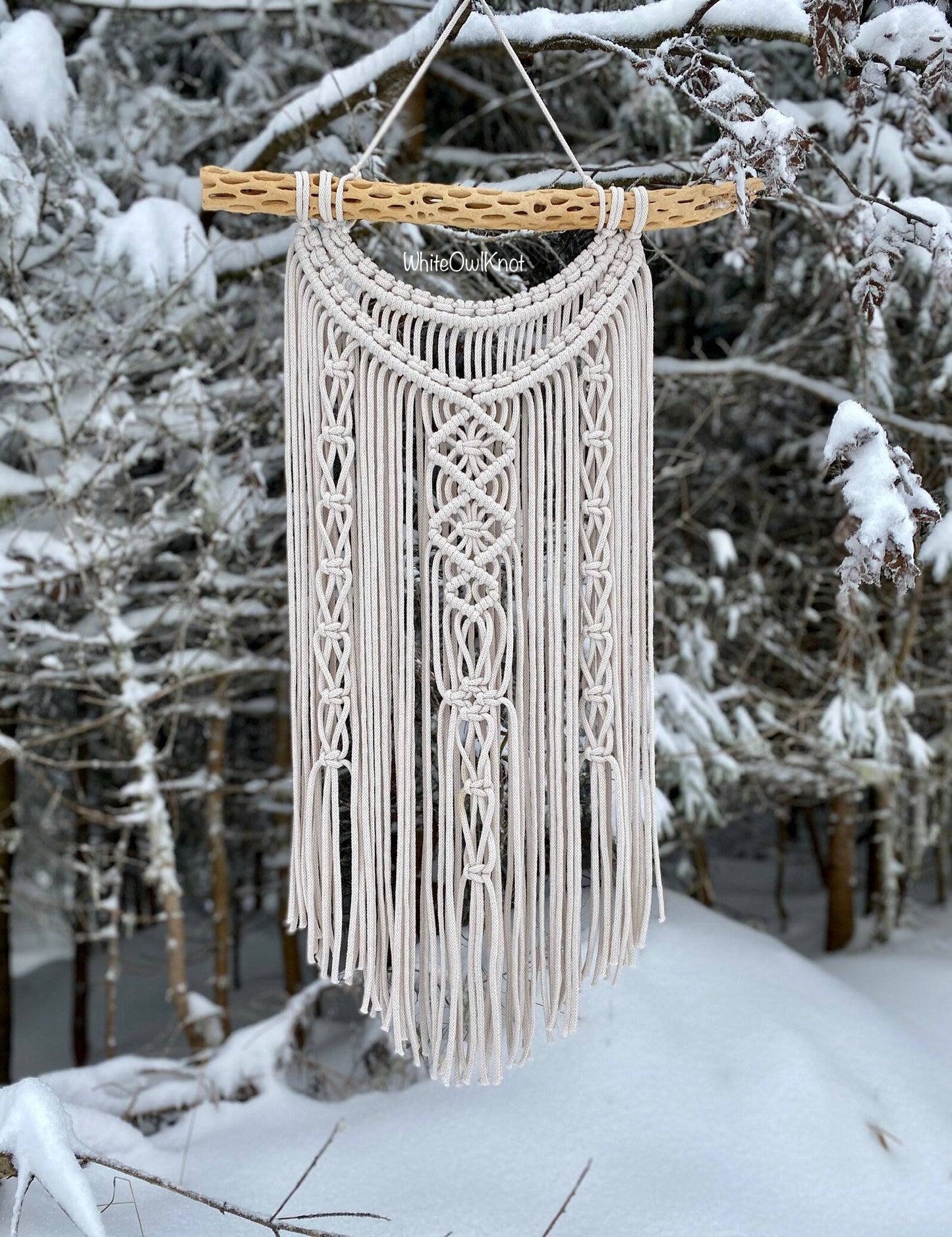 Macrame wall hanging in a snowy outdoor setting