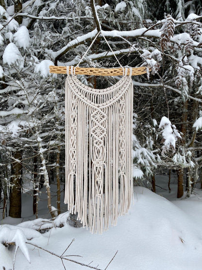 Macrame wall hanging in a snowy forest