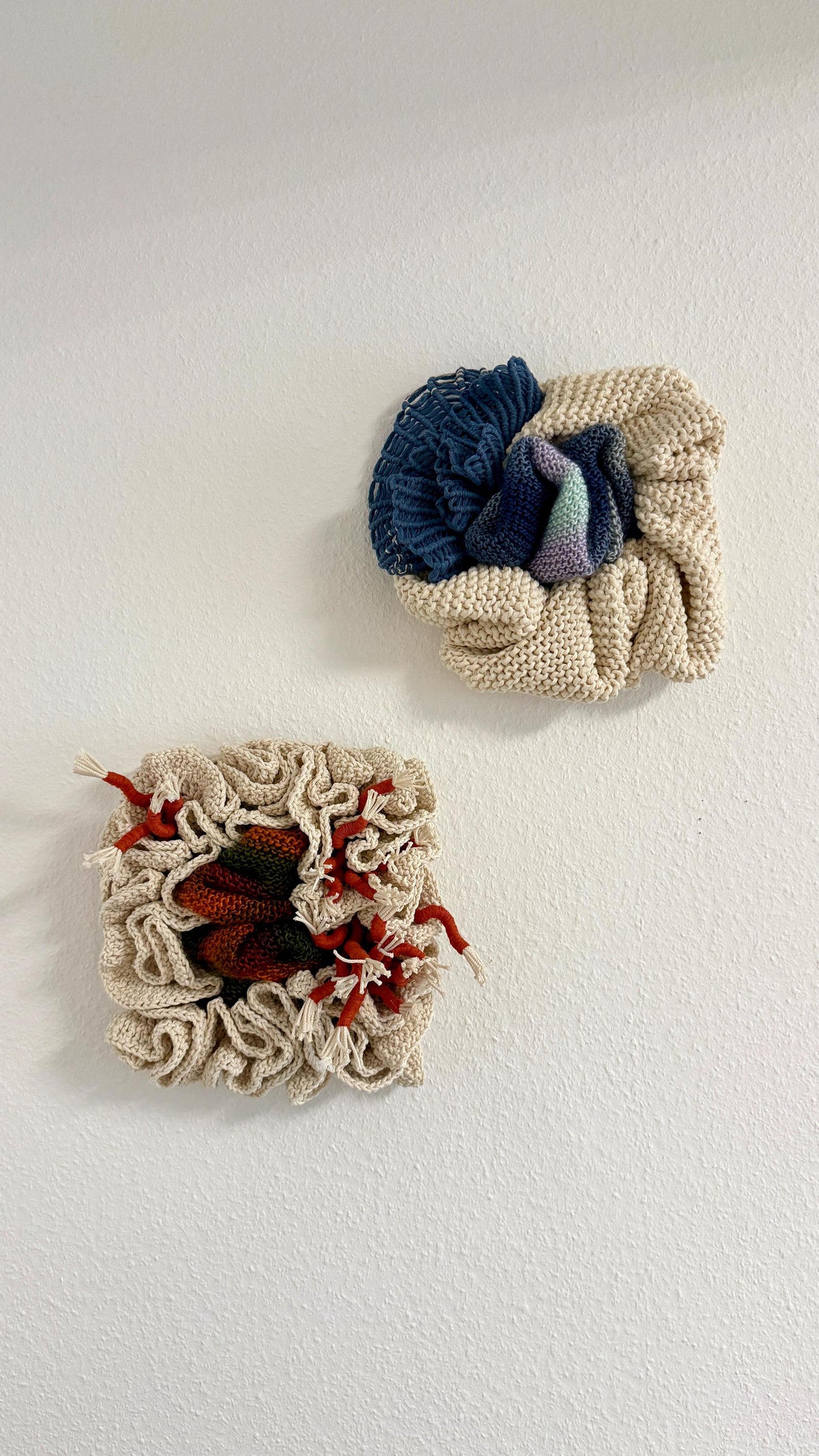 Two knitted or crocheted items with nautical patterns on a white background