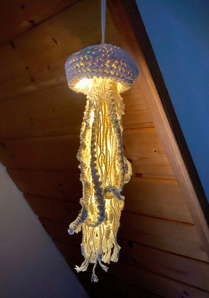 Jellyfish-shaped lamp hanging from a ceiling