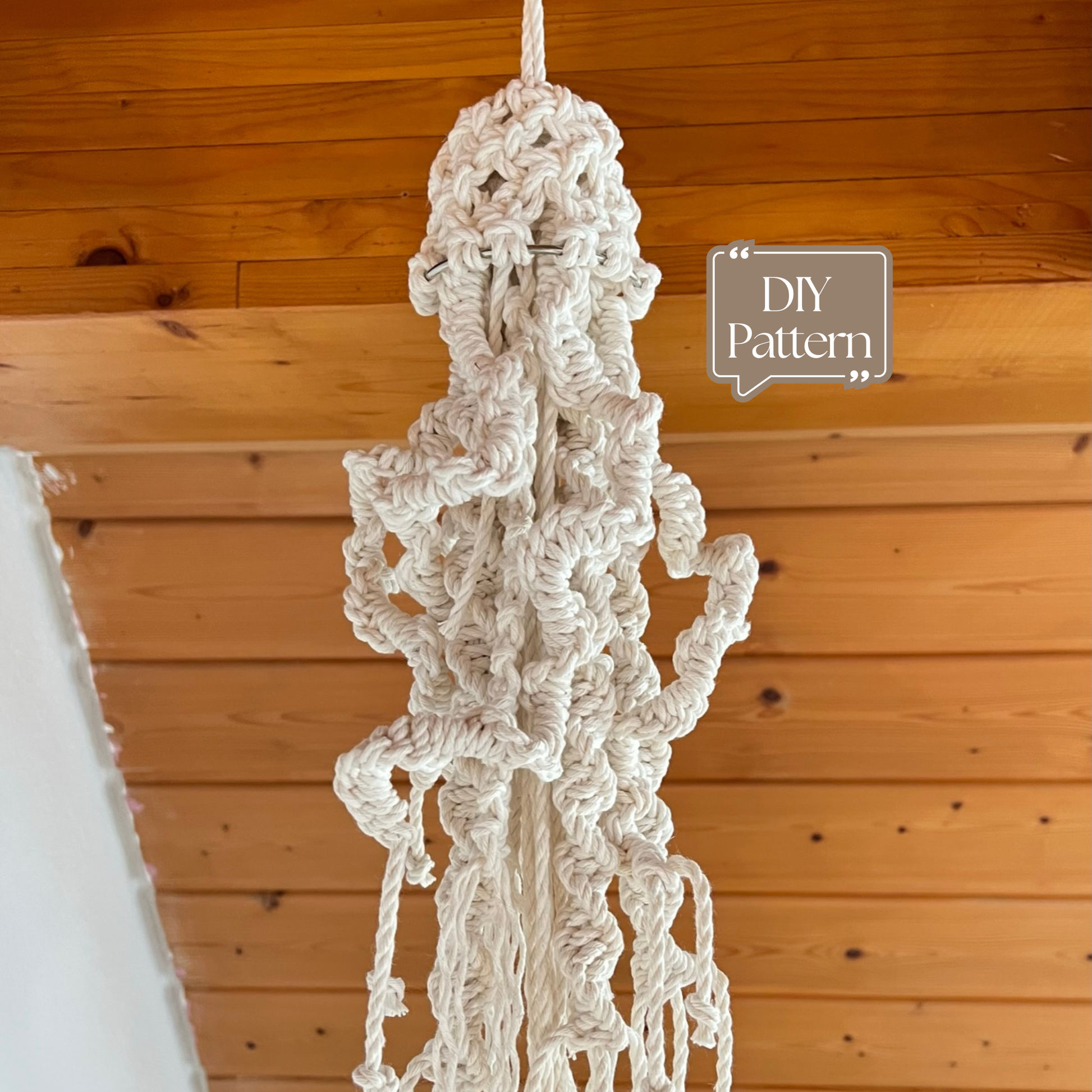 Macrame jellyfish against a wooden wall with 'DIY Pattern' text.