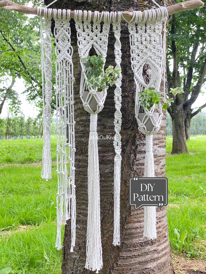 Macrame plant hangers hanging from a tree with a 'DIY Pattern' sign in a garden setting.