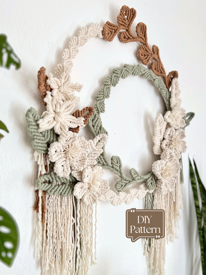 Macrame wall hanging with floral and leaf patterns on a white background