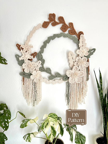 Macrame wall hanging with floral and leaf patterns on a white background