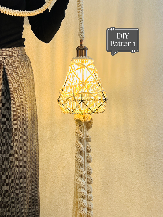 DIY macrame pendant light with woven rope lampshade and textured knotted cord, warm glowing hanging lamp shown indoors against a neutral wall.