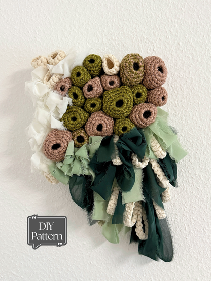 Crocheted flower arrangement with ribbons on a white background, featuring a 'DIY Pattern' label.