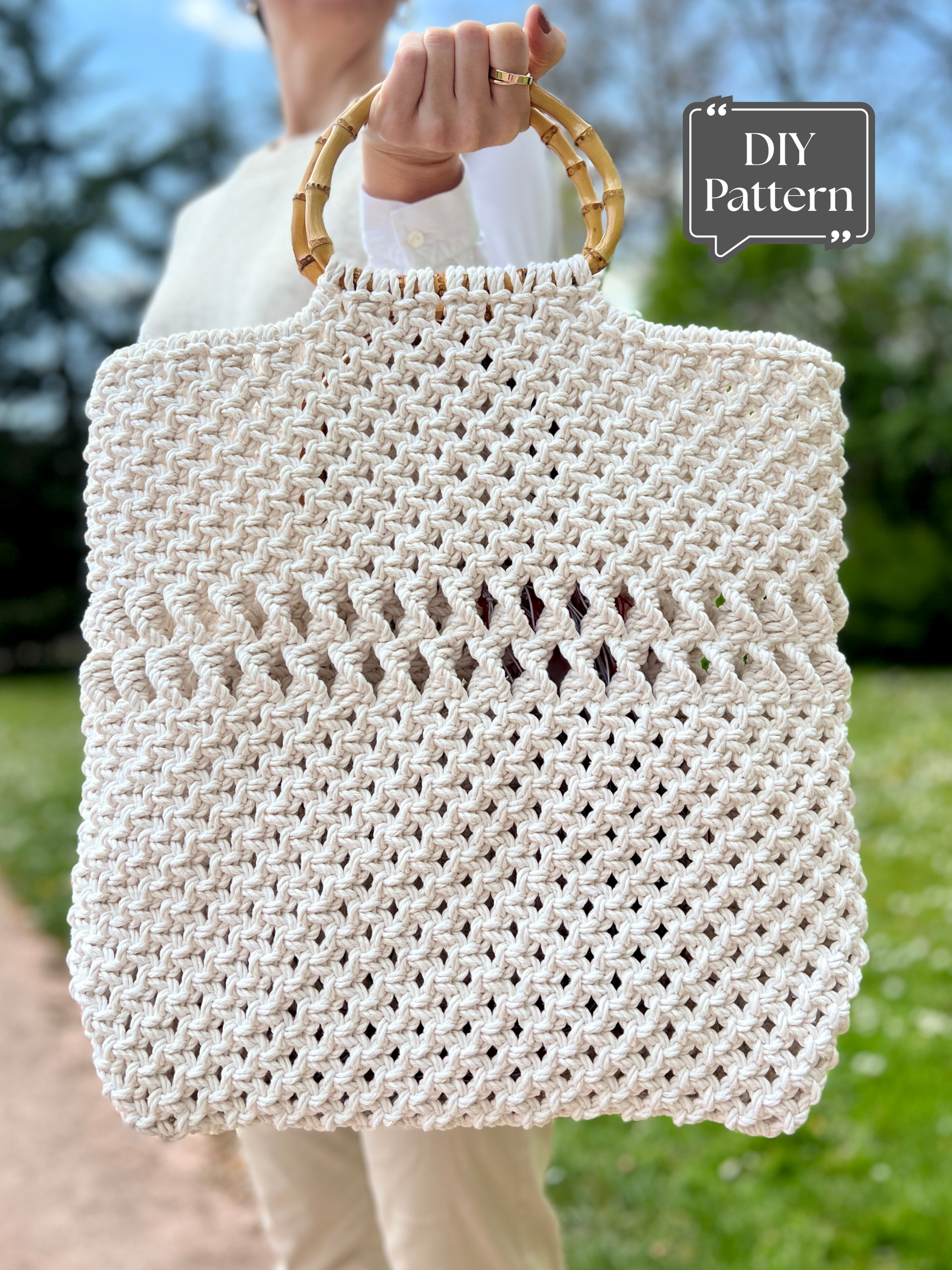 Macrame tote bag with bamboo handles, handmade white rope handbag shown outdoors as DIY pattern example