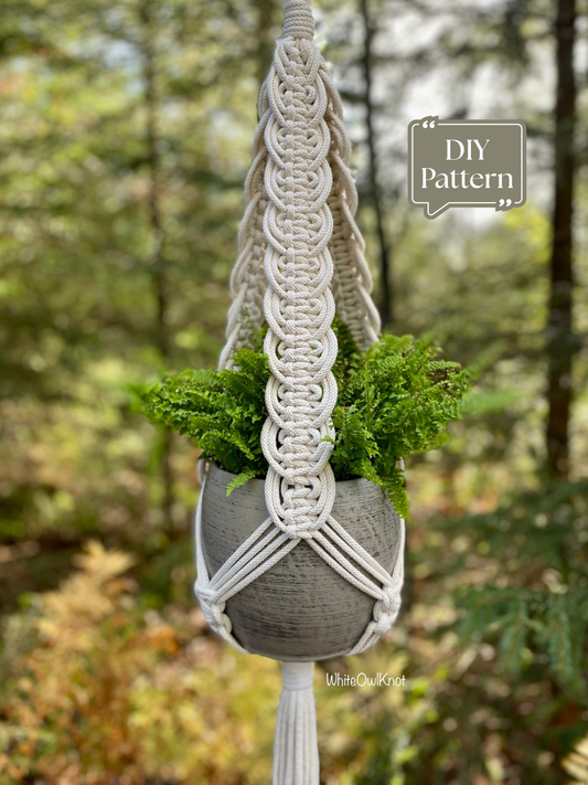 DIY macrame plant hanger PDF pattern in natural cotton cord holding a gray planter with green fern, boho hanging planter tutorial for home decor