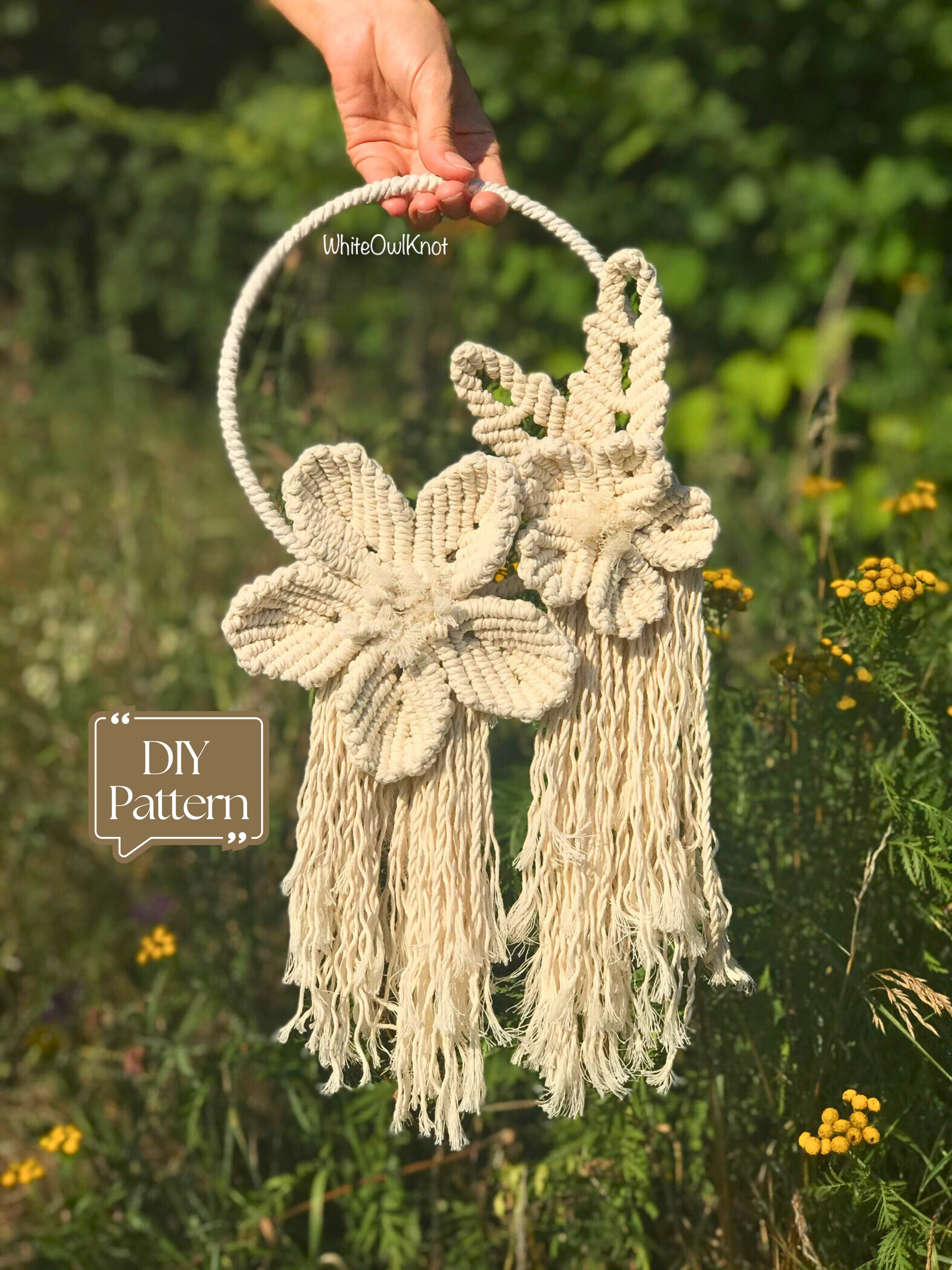 Handmade flower wreath held by a hand with a natural background with "DIY Pattern" tag