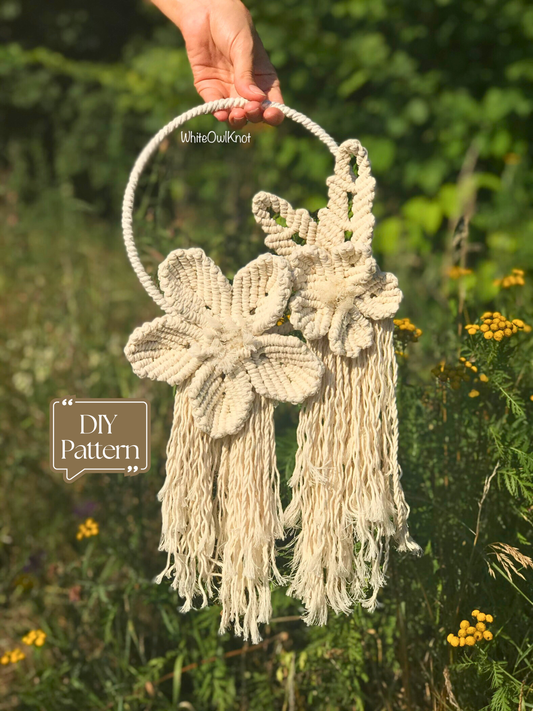 Handmade flower wreath held by a hand with a natural background with "DIY Pattern" tag