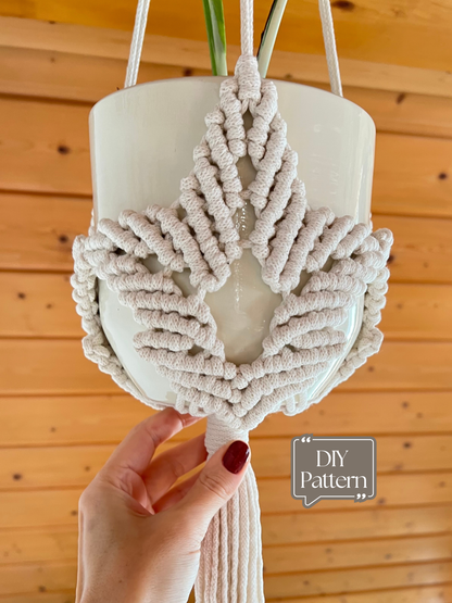 Handmade macrame plant hanger with leaf motif with a wooden background